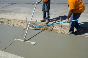 Workers laying concrete for a foundation in Allen